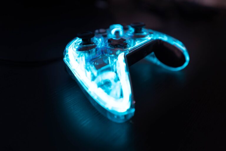 Illuminated gaming controller with blue lights on a dark background, perfect for gaming themes.